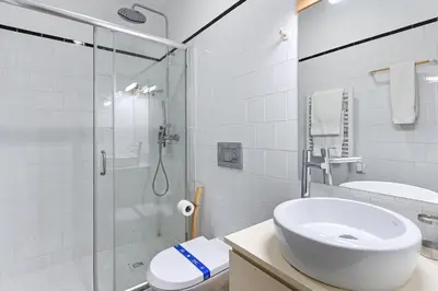 a white bathroom with a sink and a shower at ON Apartments - Garden View 2 in Porto