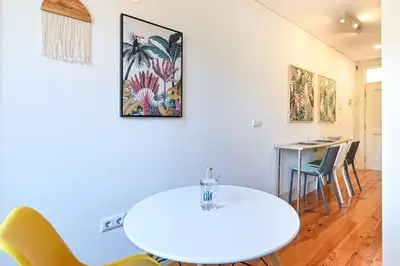 a dining room with a white table and chairs at ON Apartments - Garden View 2 in Porto
