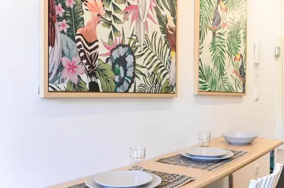 a dining room table with two plates and a painting at ON Apartments - Garden View 2 in Porto