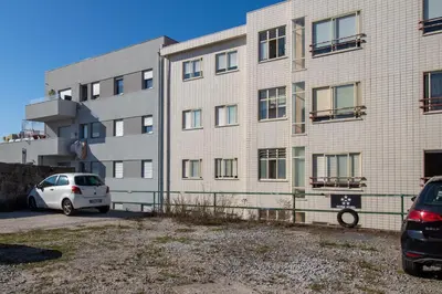 a white car parked in front of a building at Alto da Lapa House w Parking by LovelyStay in Porto