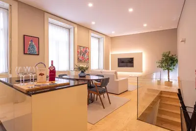 a kitchen and living room with a table with wine glasses at CC Downtown Palace - A in Porto