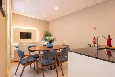a kitchen and living room with a table and chairs at CC Downtown Palace - A in Porto