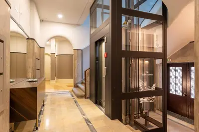 a hallway with a glass door in a building at CC Downtown Palace - A in Porto