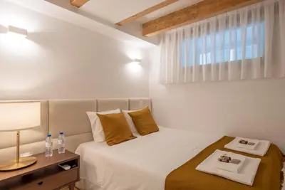 a bedroom with a bed and a table with a lamp at CC Downtown Palace - A in Porto