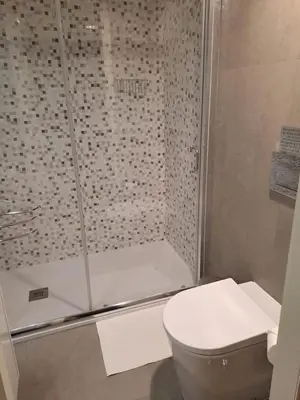 a bathroom with a shower with a toilet and a sink at CC Downtown Palace - B in Porto