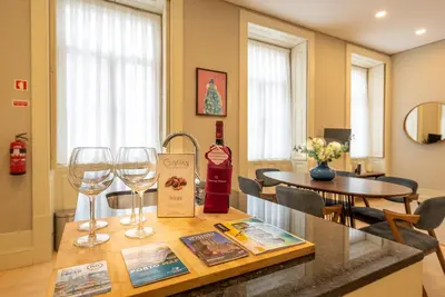 a table with two wine glasses on top of it at CC Downtown Palace - B in Porto