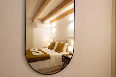 a bedroom with a bed with a mirror on the wall at CC Downtown Palace - B in Porto