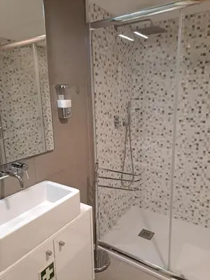 a bathroom with a shower with a sink and a shower at CC Downtown Palace - B in Porto