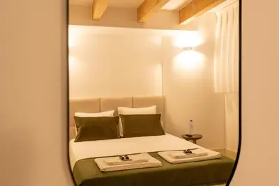 a mirror reflection of a bed in a bedroom at CC Downtown Palace - D in Porto