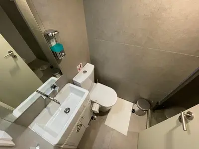 a bathroom with a white toilet and a sink at CC Downtown Palace - D in Porto