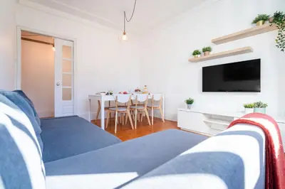 a living room with a couch and a tv at Host Wise - Spacious Comfortable Apartment - Balcony in Porto
