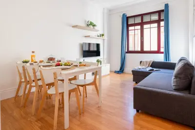 a kitchen and living room with a table and chairs at Host Wise - Spacious Comfortable Apartment - Balcony in Porto