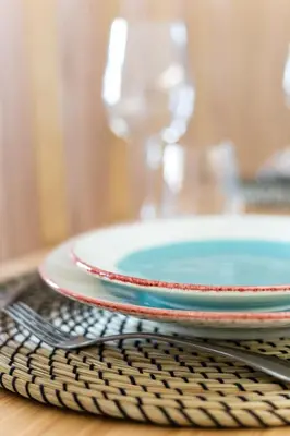a stack of plates on a table with a fork at DA'HOME - Boavista Blue Studio - NEW in Porto