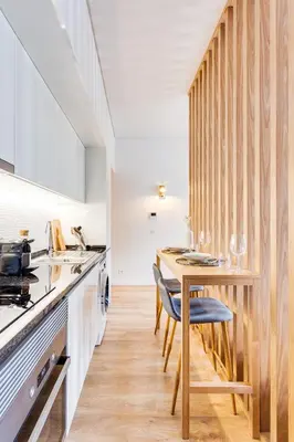 a kitchen with a wooden counter and a wooden table at DA'HOME - Boavista Blue Studio - NEW in Porto