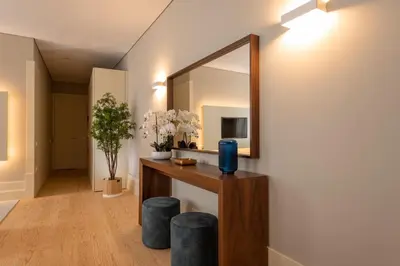 a mirror on a wall in a room with stools at CC Downtown Palace - E in Porto