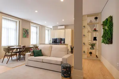 a living room with a white couch and a table at CC Downtown Palace - F in Porto