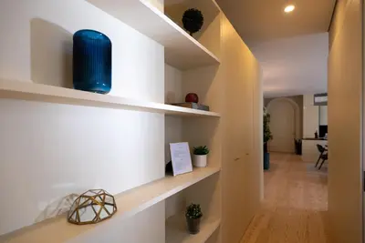 a hallway of a home with white shelves at CC Downtown Palace - G in Porto