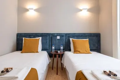 two beds sitting next to each other in a room at CC Downtown Palace - G in Porto