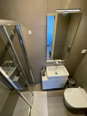 a bathroom with a sink and a mirror and a toilet at CC Downtown Palace - I in Porto