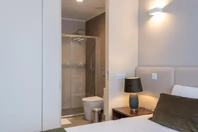 a bedroom with a shower and a bed and a lamp at CC Downtown Palace - J in Porto