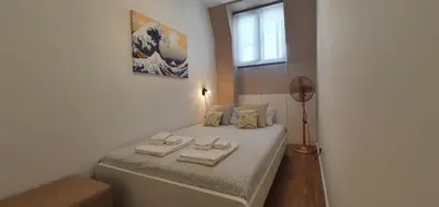 a bedroom with a bed with two towels on it at SantOporto Clérigos in Porto