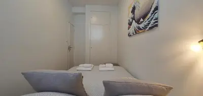 a small room with a bed and two pillows at SantOporto Clérigos in Porto