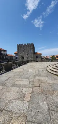 a large stone courtyard with a building in the background at SantOporto Clérigos in Porto