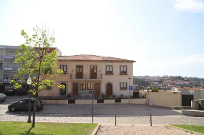a house with a car parked in front of it at Casa do Pilar - D Maria Pia in Vila Nova de Gaia