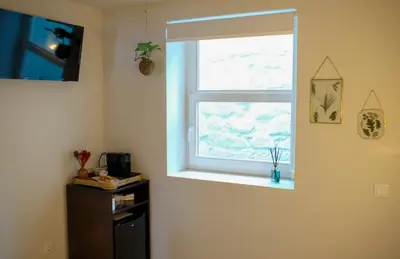 a window in a room with a dresser in front of it at Adega Floresta Residence in Porto