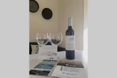 a bottle of wine and two wine glasses on a counter at Rian - central 2 bedroom Apartment in Porto in Porto