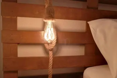 a light with a rope attached to a wall at Rian - central 2 bedroom Apartment in Porto in Porto
