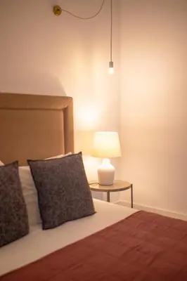 a bedroom with a bed and a table with a lamp at Bolhão - Dixo's Oporto Apartments VIII in Porto