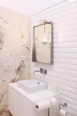 a white bathroom with a sink and a mirror at Villa Invicta in Porto