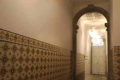a hallway with a patterned wall and a white door at Villa Invicta in Porto