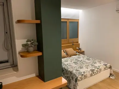a small bedroom with a bed and a green wall at Palace House Apartment in Porto