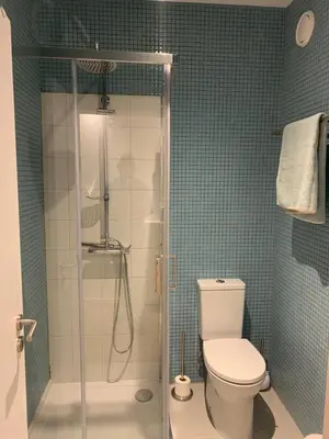 a bathroom with a toilet and a glass shower at Palace House Apartment in Porto