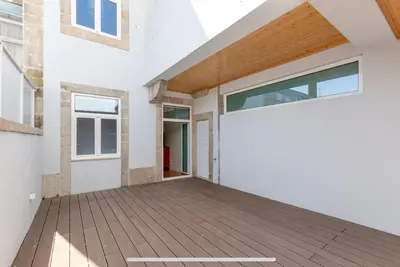a pivot door in a house with a deck at São Vítor Douro Living in Porto