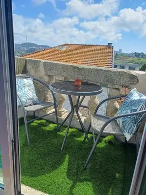 a table and chairs on a balcony with a view at São Vítor Douro Living in Porto