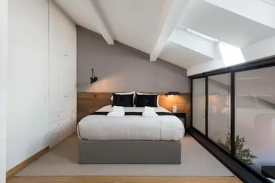 a bedroom with a bed and a large window at Modern Loft with AC in Downtown Porto by LovelyStay in Porto