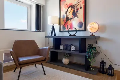 a living room with a chair and a desk at Modern Loft with AC in Downtown Porto by LovelyStay in Porto