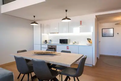 a kitchen and dining room with a table and chairs at Modern Loft with AC in Downtown Porto by LovelyStay in Porto