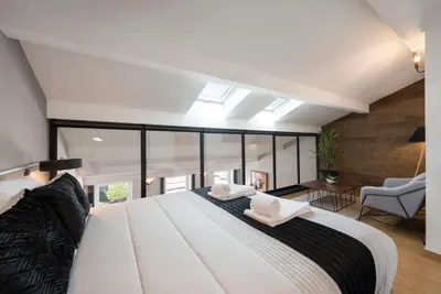 a bedroom with a large white bed and a window at Modern Loft with AC in Downtown Porto by LovelyStay in Porto