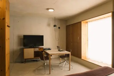 a room with a desk and a television and a table with chairs at JAM Porto in Porto