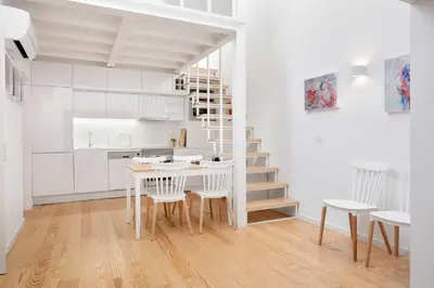 a kitchen and dining room with a table and chairs at Oporto Classic Terrace in Porto