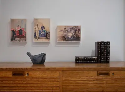 a wooden dresser with pictures on the wall at Oporto Classic Terrace in Porto