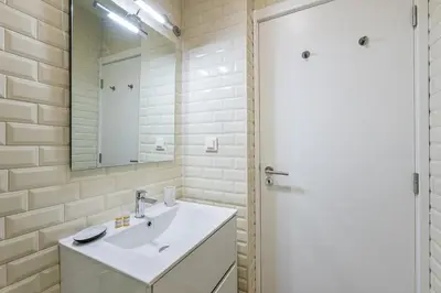 a bathroom with a sink and a mirror at GuestReady - The Art of Music in Porto
