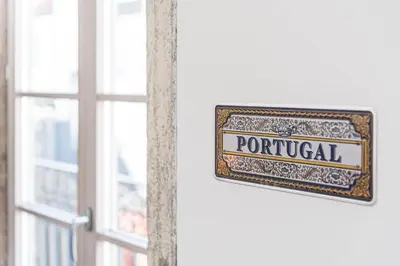a sign that reads portugal next to a window at GuestReady - The Art of Music in Porto