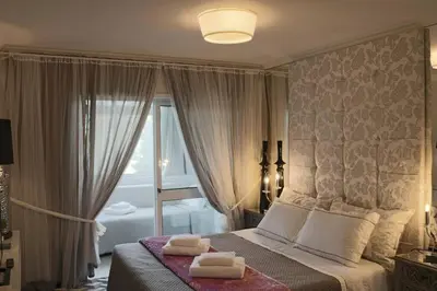 a bedroom with a bed with two towels on it at Romantic Getaway Suite in Porto