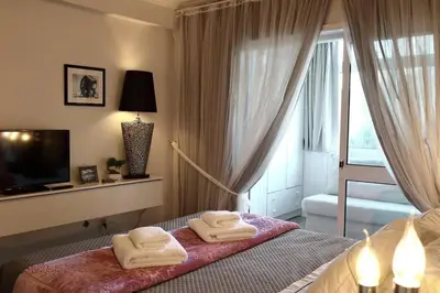 a bedroom with a bed with towels on it at Romantic Getaway Suite in Porto