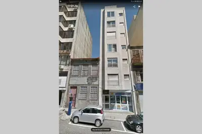 a car parked in a parking lot in front of buildings at Romantic Getaway Suite in Porto